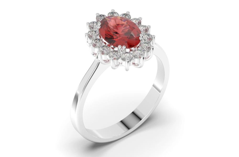 anillo de oro blanco en forma de flor con un rubí central en talla oval como protagonista y rodeado de diamantes talla brillante